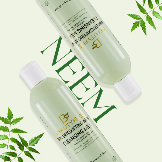 Two bottles of BEAUTYFILE cleansing milks with neem leaves on a white background