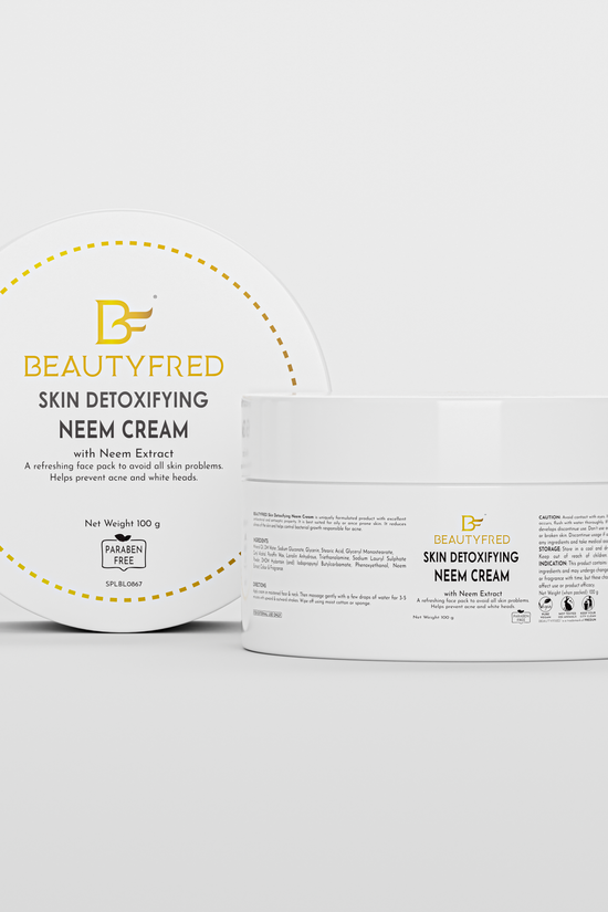 The image shows a product packaging for Beauty Fred skin care cream. The packaging is predominantly white with yellow accents, and it is a round container with a lid.